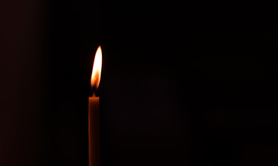 simple background pattern one soft focus candle in dark environment with empty copy space for your text or inscription, pray or mourning concept photography