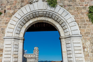 The leaning tower of pisa viewed through entrace arch of Piazza dei Miracoli in Pisa, Italy