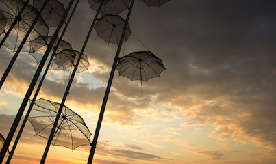 street umbrellas exterior design objects  on evening cloudy dramatic sky background from below,...