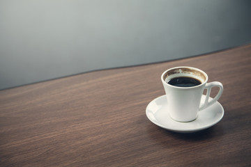 White coffee cup on a wooden desk.