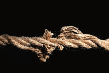 Rupture of cotton rope on black background