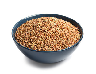 Bowl with uncooked buckwheat on white background
