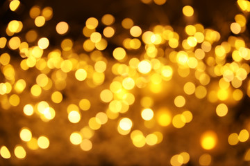 Fototapeta premium Gold glitter with bokeh effect on dark background