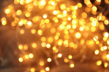Gold glitter with bokeh effect on dark background