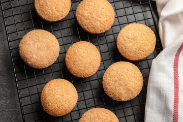 Baking grid with Danish butter cookies on grey background, top view