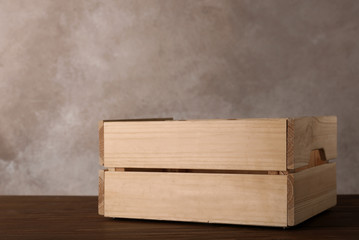 Wooden crate on table against color background. Space for text
