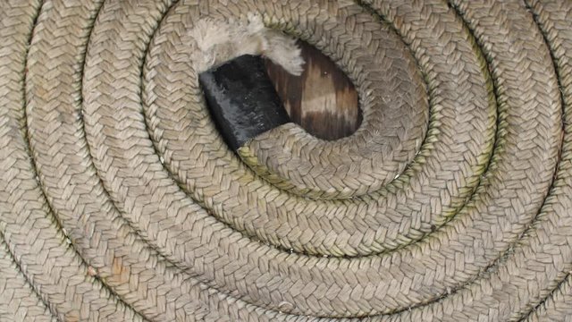 Closeup shot of a spiral rope on a sailboat deck.