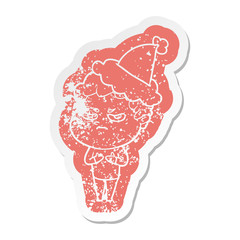 cartoon distressed sticker of a angry man wearing santa hat