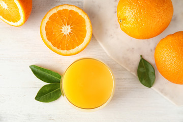 Flat lay composition with orange juice and fresh fruit on wooden background