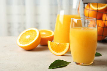 Composition with orange juice and fresh fruit on table, space for text