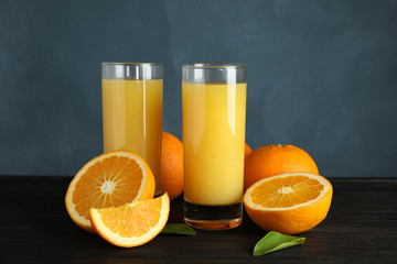 Composition with orange juice and fresh fruit on table