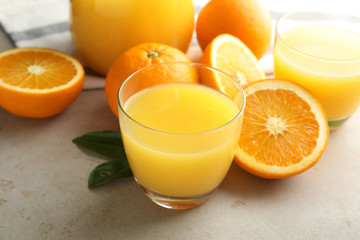 Composition with orange juice and fresh fruit on light background