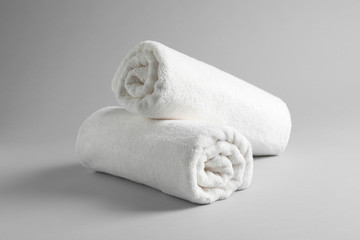 Fresh soft rolled towels on light background