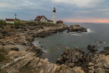 Fototapeta na wymiar Morning sunrise at Portland Head Lighthouse over rocky coast of Portland Maine.