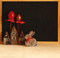 Easter background with eggs,rabbit,chalkboard