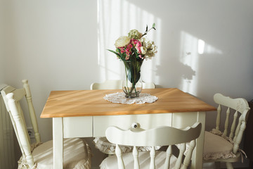 Nicely decorated living ( lunch ) room. Dining table and some chairs.