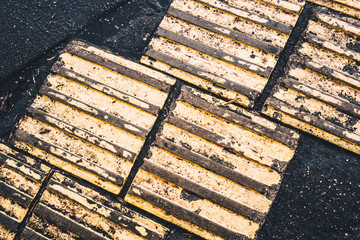 Yellow embossed tiles on asphalt