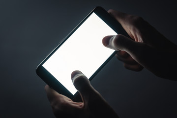 smartphone in hands with a white screen and copyspace