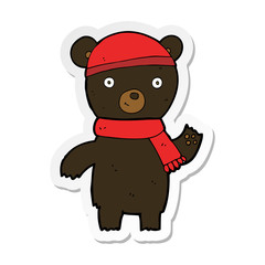 sticker of a cartoon waving black bear