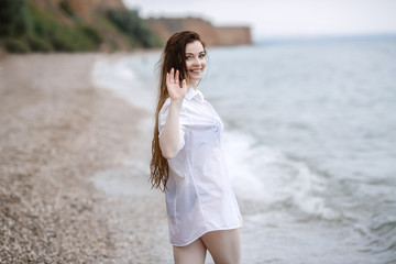 woman in white clothing refreshing at the seaside