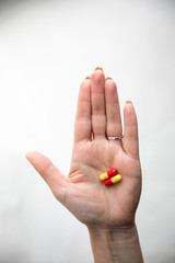 hand with pills on white background
