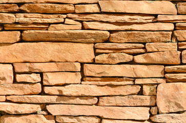 Sand colored stone setting. Stone wall texture