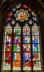 Joan of Arc scene on colorful stained glass window inside the Cathedral of the Holy Cross