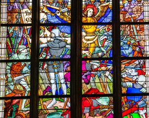 Joan of Arc war scene on colorful stained glass window inside the Cathedral of the Holy Cross in Orleans, France