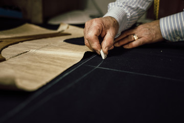 Craftsman tailor at work in the workshop - obrazy, fototapety, plakaty