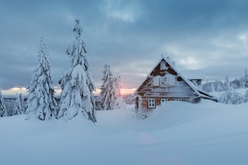 Beautiful snowy winter landscape with cottage cabin village in christmas vacation time near ski...