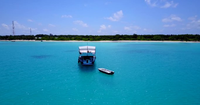 Luxury yacht vibrant clean tropical ocean, pan left 4k
