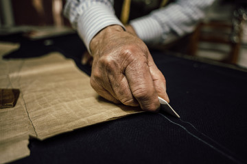 Fototapeta na wymiar Craftsman tailor at work in the workshop