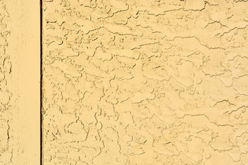 Yellow mortar wall texture with wooden border