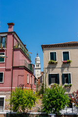 Fototapeta na wymiar Italy, Venice, a large brick building with a clock on the side of a house