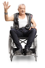 Mature male punker in a wheelchair smilig and waving