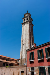 Fototapeta premium Italy, Venice, a large brick tower with a clock on the side of a building