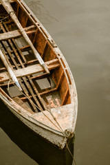  wooden rowing boat anchored on the shore in totally calm waters, on the large island of Chiloe, Chilean Patagonia