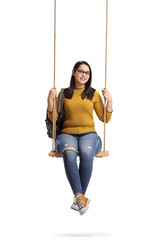Female student with a backpack sitting on a wooden swing