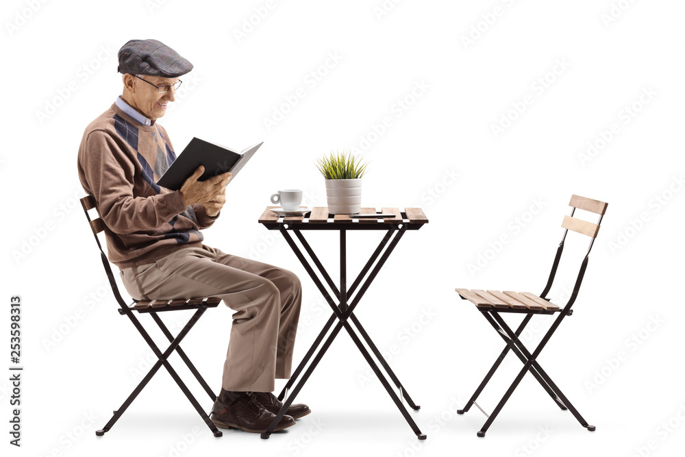 Poster senior man reading a book at a coffee table