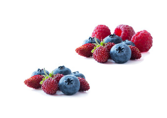 Berries isolated on white background. Ripe blueberries and wild strawberries. Background of mix berries with copy space for text. Mix berries on white background.