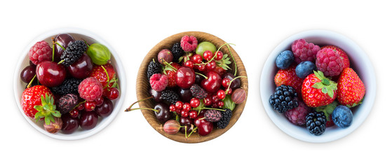 Top view. Fruits and berries in bowl isolated on white background. Ripe raspberries, cherries, strawberries, blackberries and blueberries. Background of mix fruits with copy space for text. 