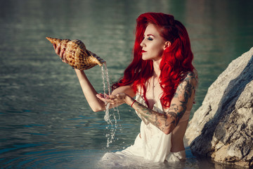 Cosplay on a  popular  mermaid , woman with red hair