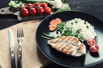 Chicken fillet on plate with rice