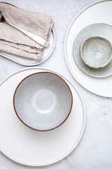 Empty plate and bowl on marble table. rustic style serving concept with copy space