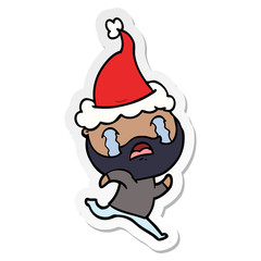 sticker cartoon of a bearded man crying wearing santa hat