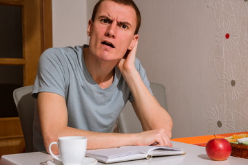 guy with a notebook in the kitchen