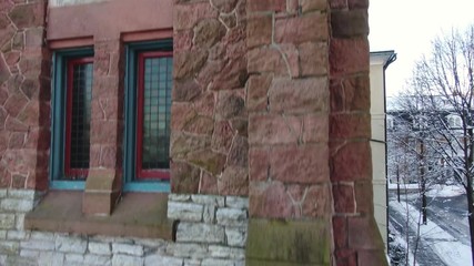 Rising shot of old fashioned brick boarding school, sun rising over snow covered town, Lititz, Pennsylvania