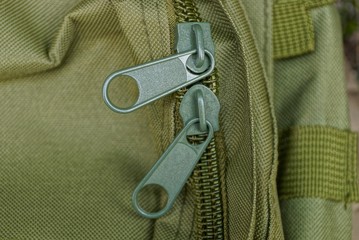 two big green metal zip on the backpack matter