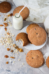 Healthy Breakfast with Oatmeal Cookies, Raisins, Oatmeal and Milk on a Light background. Concept Healthy Eating