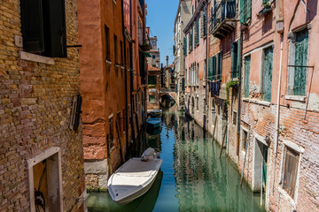Italy, Venice, Grand Canal, BOATS MOORED IN CANAL AMIDST BUILDINGS IN CITY